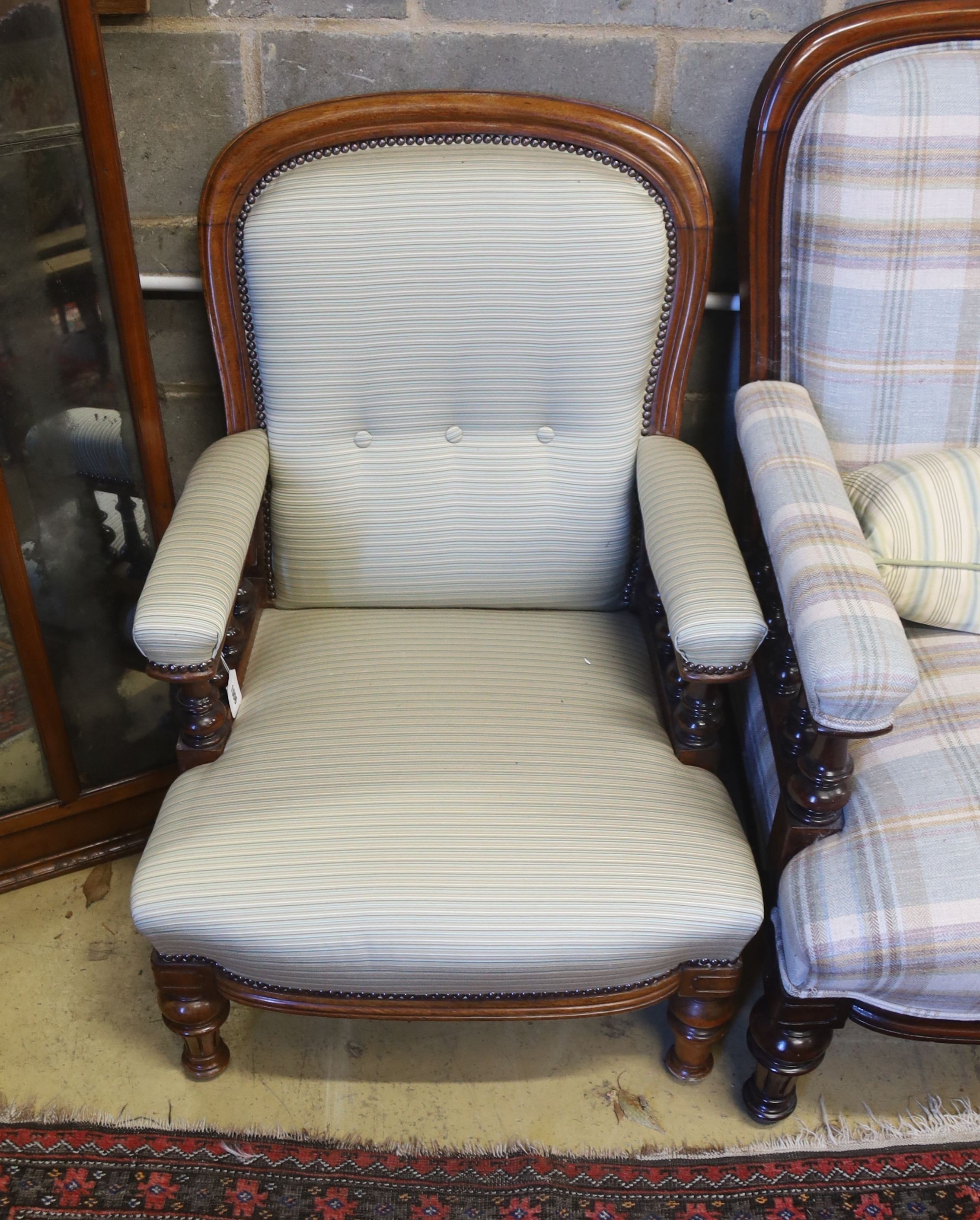 A pair of Victorian mahogany upholstered spoon back armchairs, larger width 68cm, depth 80cm, height 92cm